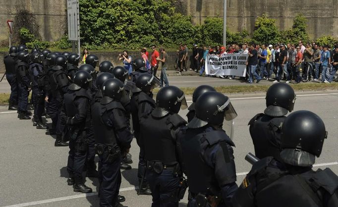 Striking coal miners protest near the El Musel seaport entrance, which is guarded by riot police, in Gijon, northern Spain, June 5, 2012. REUTERS/Eloy Alonso (SPAIN - Tags: POLITICS CIVIL UNREST BUSINESS EMPLOYMENT) Published: Čer. 5, 2012, 1:17 odp