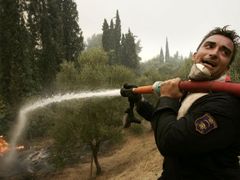 Hasič bojuje s požárem na poloostrově Peloponés