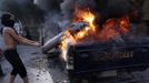 A protester sets fire to police vehicles during clashes with riot police along a road which leads to the U.S. embassy, near Tahrir Square in Cairo September 13, 2012. Egypt's President Mohamed Mursi said on Thursday he supported peaceful protests but not attacks on embassies, after Egyptians angry at a film deemed insulting to the Prophet Mohammad climbed into the U.S. embassy in Cairo and tore down the U.S. flag. He pledged to protect foreigners in Egypt.