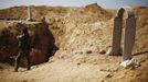 An Israeli soldier takes a picture of an entrance to a tunnel exposed by the Israeli military, just outside the southern Gaza Strip