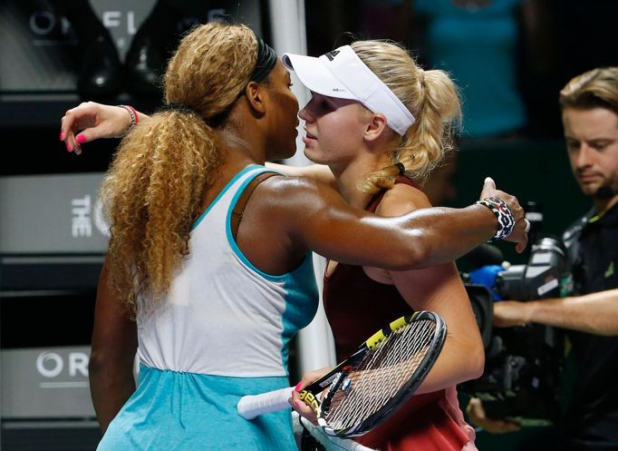 Serena Williams of the U.S. is congratulated by Caroline Wozniacki of Denmark during their WTA Finals singles semi-final tennis match at the Singapore Indoor Stadium Octo