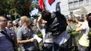 protester uses a megaphone to shout slogans during a protest outside the Japanese embassy (in the background) in Beijing September 15, 2012. Thousands of protesters besieged the Japanese embassy in Beijing on Saturday, hurling rocks and bottles at the building as police struggled to keep control, amid growing tensions between Asia's two biggest economies over a group of disputed islands. REUTERS/Jason Lee (CHINA - Tags: CIVIL UNREST POLITICS)