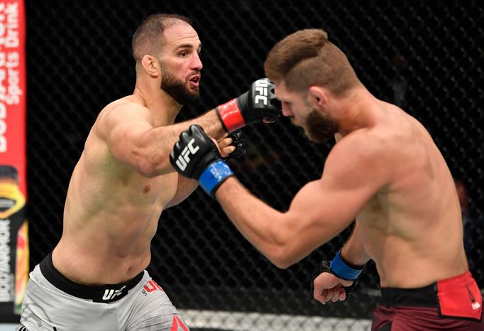 July 12, 2020; Abu Dhabi, UAE; Volkan Oezdemir of Switzerland punches Jiri Prochazka of the Czech Republic in their light heavyweight fight during the UFC 251 event at Fl