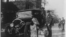 4. Black-and-white photograph of policeman standing alongside wrecked car and cases of moonshine liquor. Courtesy of the Prints and Photographs Division, Library of Congress, Washington, D. C.