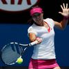 Li Na of China hits a return to Belinda Bencic of Switzerland during their women's singles match at the Australian Open 2014 tennis tournament in Melbourne