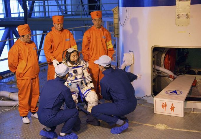 Jeden s astronautů, Jing Haipeng se připravuje k nácviku nástupu na loď.