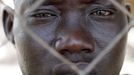 South Sudan SPLA soldier looks at his injured comrades outside a hospital in Bentiu