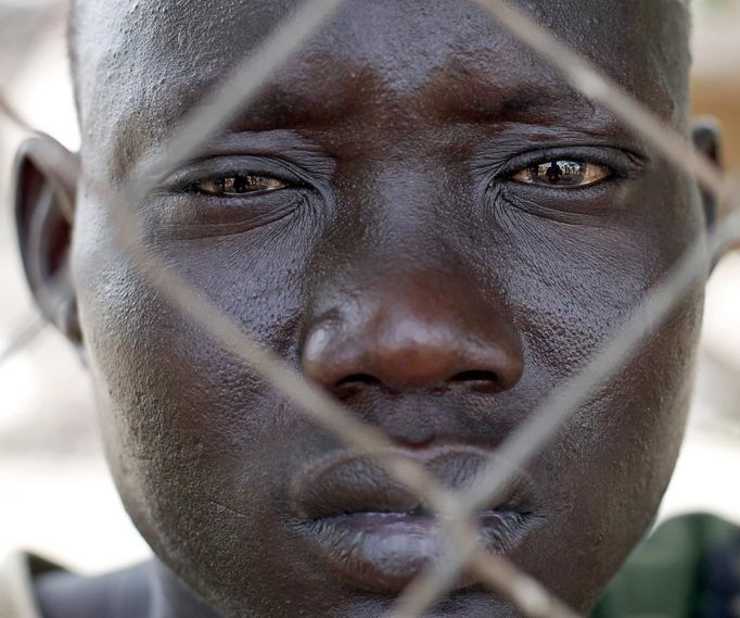 South Sudan SPLA soldier looks at his injured comrades outside a hospital in Bentiu