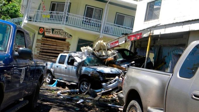 Tsunami za sebou nechala převrácená a pomačkaná auta. Jako tady na snímku z vesnice Si'umu, Západní Samoa.