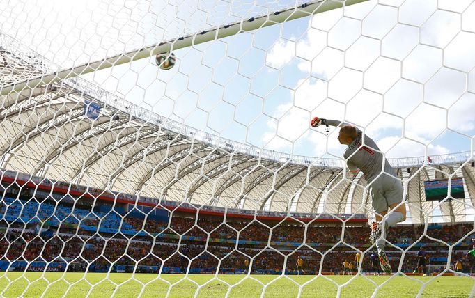 Goalkeeper Jasper Cillessen of the Netherlands lets in a goal by Australia's Tim Cahill during their 2014 World Cup Group B soccer match at the Beira Rio stadium in Porto