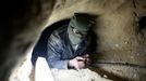 A Palestinian lies inside an 800-meter-long clandestine tunnel at Rafah, on the Egyptian-Gaza border, Feb. 13, 2007. The tunnels are used to smuggle goods, weapons, explosives and militants from Egypt into the Gaza Strip. Israel claims militants have smuggled large quantities of weapons over the border since Israel's unilateral withdrawal from Gaza last summer.