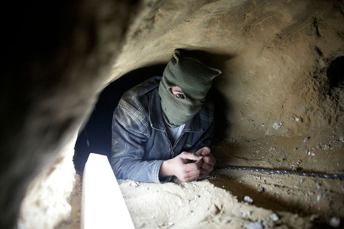 A Palestinian lies inside an 800-meter-long clandestine tunnel at Rafah, on the Egyptian-Gaza border, Feb. 13, 2007. The tunnels are used to smuggle goods, weapons, explosives and militants from Egypt into the Gaza Strip. Israel claims militants have smuggled large quantities of weapons over the border since Israel's unilateral withdrawal from Gaza last summer.