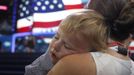 A convention-goer holds a child on the convention floor on the first day of the Democratic National Convention in Charlotte, North Carolina, September 4, 2012. REUTERS/Jessica Rinaldi (UNITED STATES - Tags: POLITICS ELECTIONS) Published: Zář. 4, 2012, 9:52 odp.