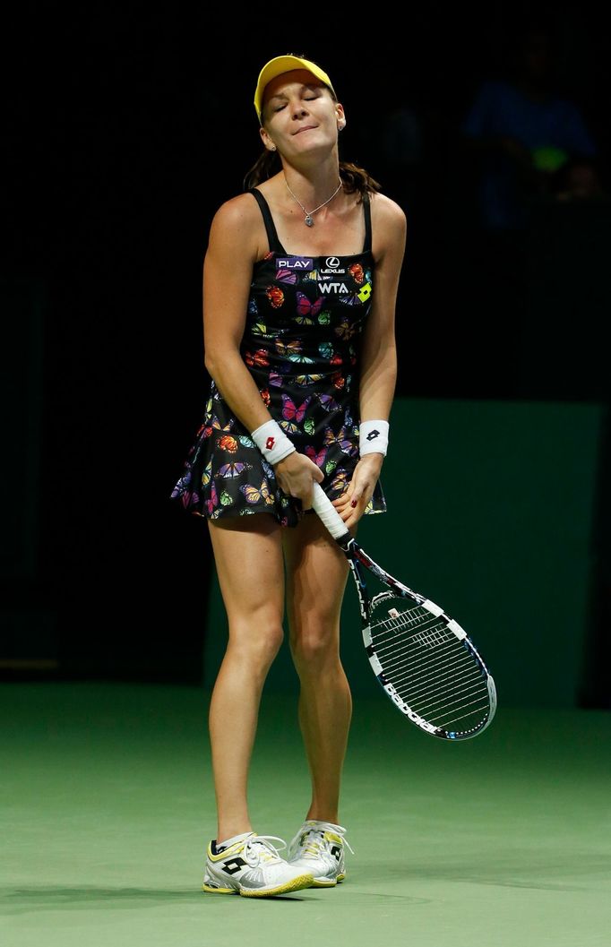 Agnieszka Radwanska of Poland reacts after losing a point against Petra Kvitova of the Czech Republic during their WTA Finals singles tennis match at the Singapore Indoor