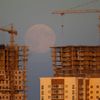 The supermoon is seen behind a building site in Minsk