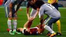 AS Roma's Alessandro Florenzi (C) lies on the pitch during the match against Real Madrid.