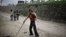 Drumpal Choudhary, 11, a street performer, walks on a street of Kathmandu August 15, 2012. Drumpal and his siblings, Shivani and Gchan, who came to Kathmandu from India 5 years ago, earn their living by performing tricks on the streets of Kathmandu. According to Drumpal, they earn around $10 a day by performing tricks, which is not enough to feed their 10-member family living together in a small hut without a proper toilet or any basic needs. REUTERS/Navesh Chitrakar (NEPAL - Tags: SOCIETY IMMIGRATION POVERTY) Published: Srp. 15, 2012, 4:27 odp.