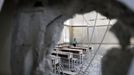 A boy stands in a classroom at his school after it was hit by a Saudi-led air strike in Yemen's capital Sanaa July 20, 2015.