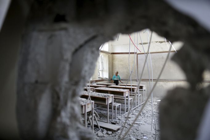 A boy stands in a classroom at his school after it was hit by a Saudi-led air strike in Yemen's capital Sanaa July 20, 2015.