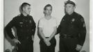 Lee Harvey Oswald, accused of assassinating former U.S. President John F. Kennedy, is pictured with Dallas police Sgt. Warren (R) and a fellow officer in Dallas, in this handout image taken on November 22, 1963