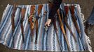 John Laigaie III, a retired Army master sergeant, lays out guns he and two other friends purchased on the periphery of the Seattle Police Department's gun buyback event in Seattle on Saturday, Jan. 26, 2013. Many independent gun buyers and sellers operated on the periphery of the official buyback, offering Amazon gift cards in exchange for firearms. (AP Photo/The Seattle Times, Bettina Hansen) MAGS OUT; NO SALES; SEATTLEPI.COM OUT; MANDATORY CREDIT; TV OUT; USA TODAY OUT