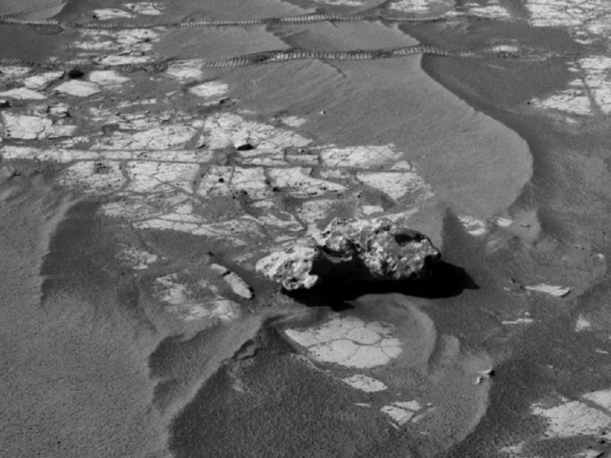 Opportunity's Close-up of 'Oileán Ruaidh' (Left Eye) An iron meteorite is the latest quarry for NASA's Mars Exploration Rover Opportunity. The rover's cameras revealed the meteorite on its trek to its long-term destination, Endeavour crater, in images taken on Sol 2363 (Sept. 16, 2010), the 2,363rd Martian day of the rover's mission on Mars. This view was taken with the navigation camera on Sol 2368 (Sept. 21, 2010), after a drive the preceding sol to get close to the rock. The meteorite is about half a meter (20 inches) long. This image is the left-eye member of a stereo pair. The science team used two tools on Opportunity's arm -- the microscopic imager and the alpha particle X-ray spectrometer -- to inspect the rock's texture and composition. The team informally named the rock "Oileán Ruaidh" (pronounced ay-lan ruah), which is the Gaelic name for an island off the coast of northwestern Ireland. Opportunity departed Oileán Ruaidh and resumed its journey toward Endeavour on Sol 2374 (Sept. 28, 2010) with a drive of about 100 meters (328 feet). Image credit: NASA/JPL-Caltech