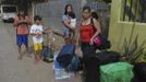 Residents wait for a truck to transport them into an evacuation center as local officials ordered enforced evacuation ahead of Typhoon Bopha in Cagayan de Oro City, southern Philippines December 3, 2012. Philippine President Benigno Aquino told people on Monday to take storm warnings seriously as authorities evacuated thousands of residents of coastal and mountain regions hours before the biggest typhoon this year was due to hit. REUTERS/Stringer (PHILIPPINES - Tags: POLITICS ENVIRONMENT SOCIETY DISASTER) Published: Pro. 3, 2012, 12:31 odp.