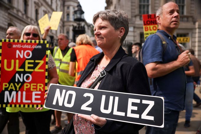 People protest at a demonstration outside the Houses of Parliament against the expansion of London's Ultra Low Emissions Zone (ULEZ), which involves the installation of h