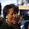 Lorraine Womble wipes her eye at a vigil to celebrate the life and music of deceased musician Prince in Los Angeles