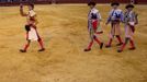 Spanish matador Fernandez celebrates next to his assistants after wining the ear of a bull during a bullfight in Seville