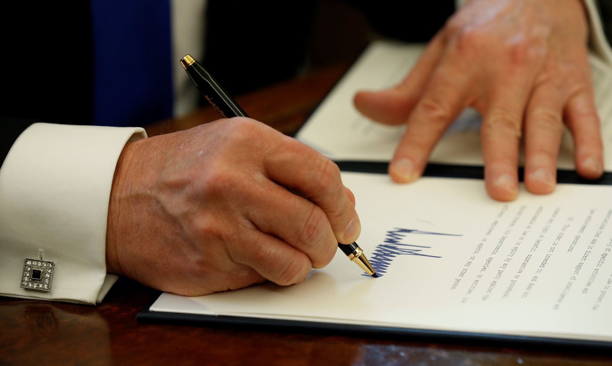 Donald Trump podepisuje v Bílém domě exekutivní nařízení.