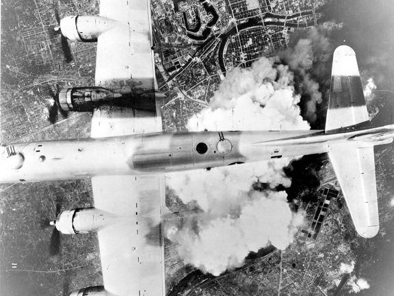 Boeing B-29A-45-BN Superfortress při bombardování japonského města Ósaka. Před svžením atomových bomb Američané podobných útoků konvečními zbraněmi provedli tisíce.