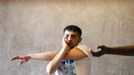 Unemployed Belgian Mohamed Sammar stretches as he takes part in a "Fit for a job" boxing class in Brussels June 14, 2013. Sammar, 27, has been looking for a job in the construction sector for 2 years. "Fit for a job" is the initiative of former Belgian boxing champion Bea Diallo, whose goal was to restore the confidence of unemployed people and help them find a job through their participation in sports. Picture taken June 14, 2013. REUTERS/Francois Lenoir (BELGIUM - Tags: SPORT BOXING SOCIETY BUSINESS EMPLOYMENT) Published: Čec. 5, 2013, 3:59 odp.