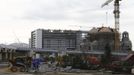 A church is built next to the Olympic stadium (L) for the Sochi 2014 Winter Olympics, at the seafront within the perimeters of the Olympic Park in Adler, near Sochi February 18, 2013. Although many complexes and venues in the Black Sea resort of Sochi mostly resemble building sites that are still under construction, there is nothing to suggest any concern over readiness. Construction will be completed by August 2013 according to organizers. The Sochi 2014 Winter Olympics opens on February 7, 2014. REUTERS/Kai Pfaffenbach (RUSSIA - Tags: BUSINESS CONSTRUCTION CITYSCAPE ENVIRONMENT SPORT OLYMPICS RELIGION) Published: Úno. 18, 2013, 7:44 odp.