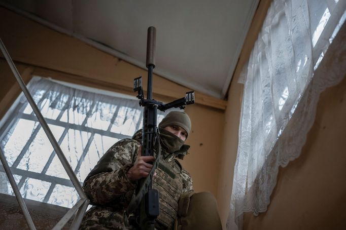 A Ukrainian Army sniper carries his rifle at a temporary base near a front line, amid Russia's attack on Ukraine, in Donetsk region, Ukraine December 23, 2023. REUTERS/Vi