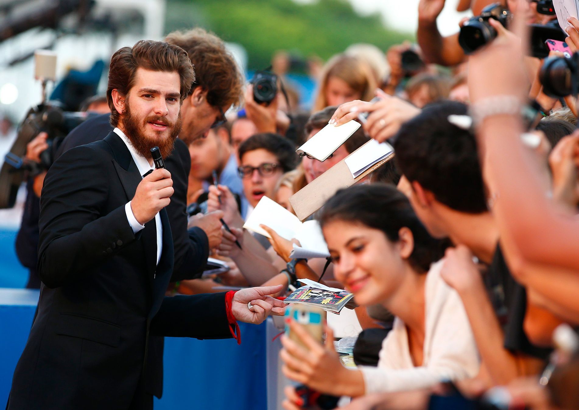 Actor Garfield signs autographs during the red carpet for the movie &quot;99 Homes&quot;  at the 71st Venice Film Festival