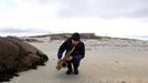 Artist and poet Barry Edgar Pilcher plays the saxaphone on the beach of the Island of Inishfree in County Donegal, May 1, 2012. REUTERS/Cathal McNaughton