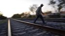 Edgar crosses the train tracks next to a train carriage he calls home in Cadereyta on the outskirts of Monterrey August 8, 2012. Edgar, his eight other family members and their pets have been living in the abandoned carriage next to a train track for the last 15 years. Edgar's parents moved from Tamaulipas to Cadereyta after Edgar's brother was killed on the street by a stray bullet. The family moved into the carriage, which was empty after having been occupied by a vagabond, after living for the first five years in a rented room after arriving in Cadereyta. Picture taken August 8, 2012. REUTERS/Daniel Becerril (MEXICO - Tags: SOCIETY) Published: Srp. 11, 2012, 2:51 dop.