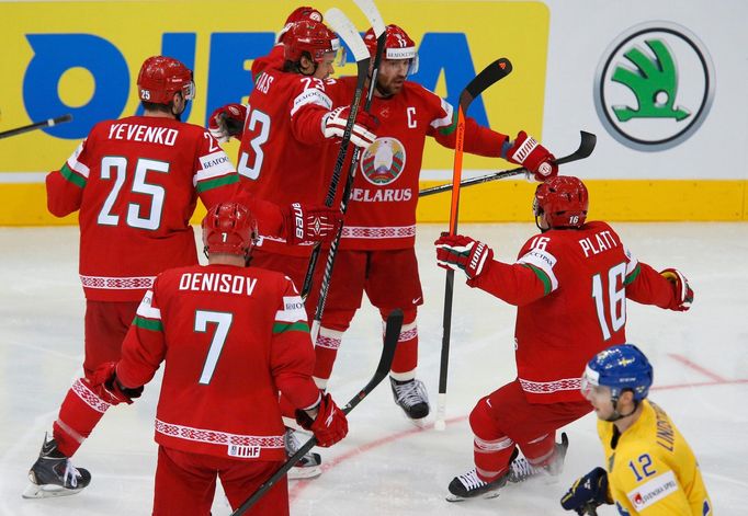 Geoff Platt of Belarus (R) celebrates with his team mates after scoring a goal against Sweden during the second period of their men's ice hockey World Championship quarte