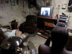 Kubánci sledují na televizní obrazovce informace o Castrově zdravotním stavu.