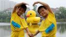 WUHAN, CHINA - JUNE 01: (CHINA OUT) Visitors look at a giant rubber duck on June 1, 2013 in Wuhan, Hubei province of China. The six-meter tall rubber duck is on shown in the city beginning on June 1 to celebrate the International Children's Day. The duck is a copy of Dutch artist Florentijn Hofman's original giant 16.5-m tall 'Rubber Duck', which was on shown in May 2013 in Hong Kong.