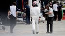 McLaren Honda Formula One driver Jenson Button of Britain walks to his team garage during the qualifying session of the Australian F1 Grand Prix at the Albert Park circui