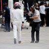 McLaren Honda Formula One driver Jenson Button of Britain walks to his team garage during the qualifying session of the Australian F1 Grand Prix at the Albert Park circuit in Melbourne