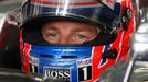 McLaren Formula One driver Jenson Button of Britain sits in his car at the pit lane during the first practice session of the Malaysian F1 Grand Prix at Sepang Internation