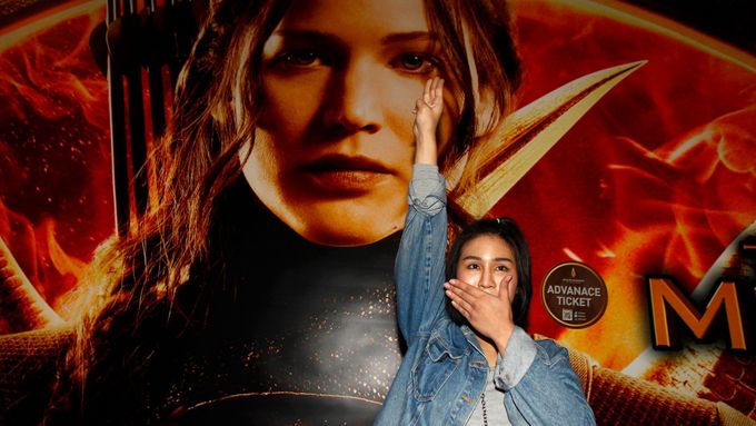 Studentka salutující před premiérou Hunger Games: Síla vzdoru část 1. v Bangkoku