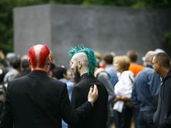 People stand in front of the new memorial to homosexuals persecuted by the Nazis, during the inauguration ceremony in Berlin May 27, 2008. The single grey concrete slab is placed in the capital's central Tiergarten park. REUTERS/Johannes Eisele (GERMANY)