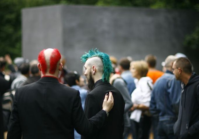 People stand in front of the new memorial to homosexuals persecuted by the Nazis, during the inauguration ceremony in Berlin May 27, 2008. The single grey concrete slab is placed in the capital's central Tiergarten park. REUTERS/Johannes Eisele (GERMANY)