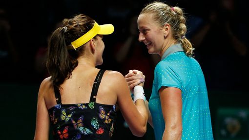 Agnieszka Radwanska of Poland (L) is congratulated by Petra Kvitova of the Czech Republic during their WTA Finals singles tennis match at the Singapore Indoor Stadium Oct
