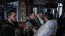 Ukrainian service members of the 4th Ivan Vyhovskyi Separate Tank Brigade attend a Christmas Eve service near the front line outside Kupiansk as Ukrainians celebrate thei