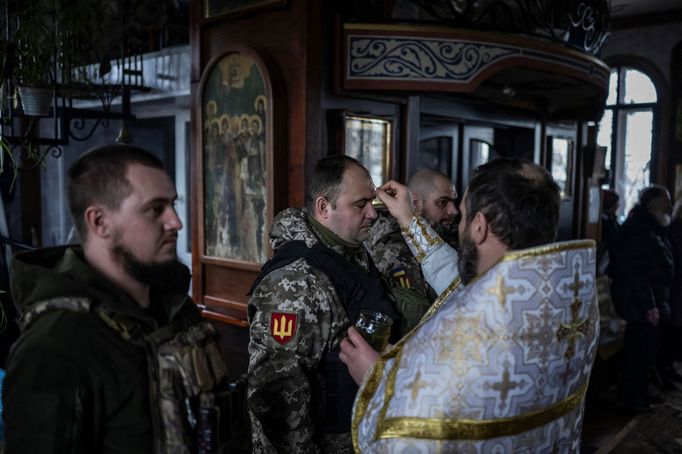 Ukrainian service members of the 4th Ivan Vyhovskyi Separate Tank Brigade attend a Christmas Eve service near the front line outside Kupiansk as Ukrainians celebrate thei